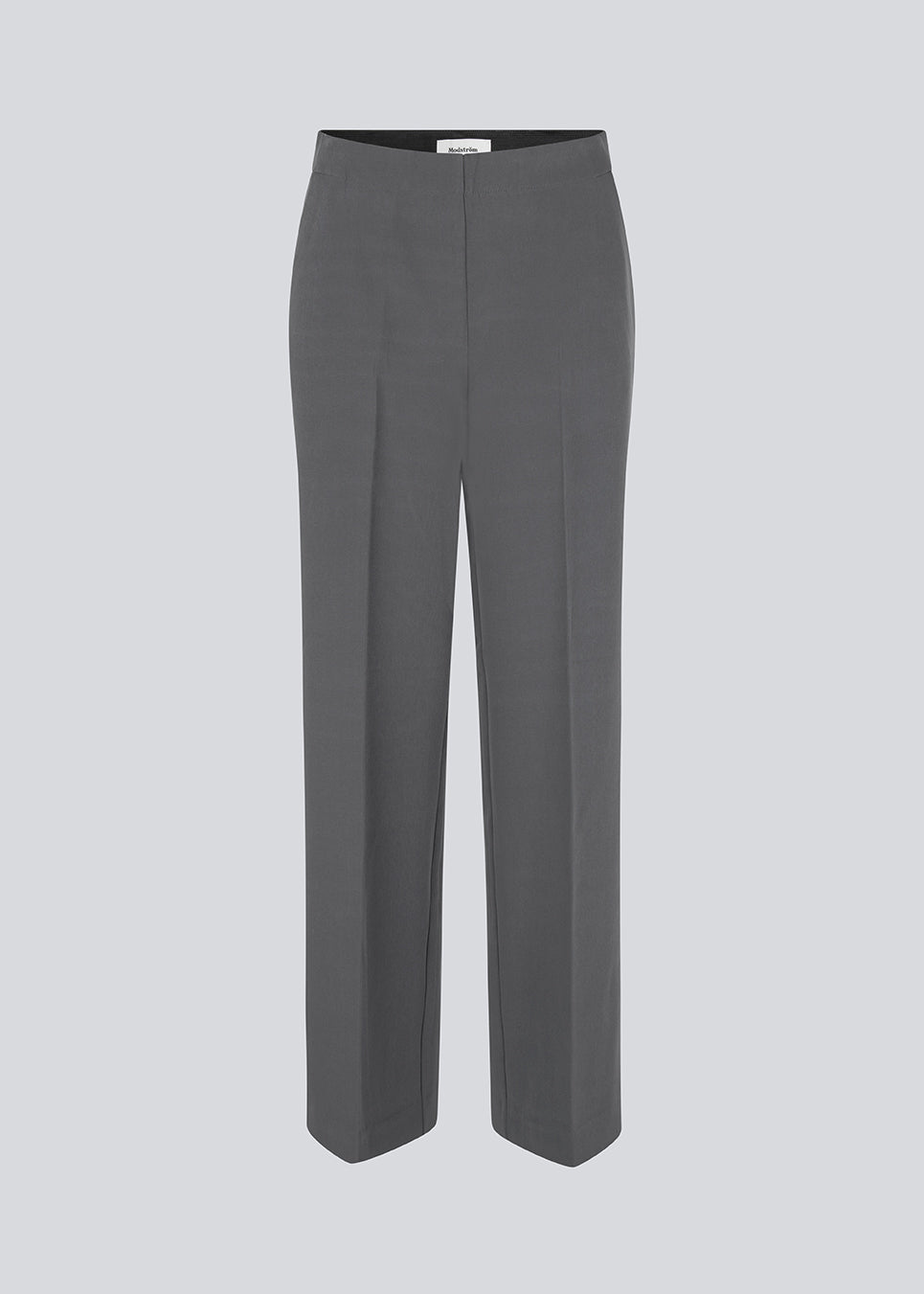 Classic pants in grey with pressfolds and straight legs. Nelli pants are closed by a hidden zipper at the side with an elastic waistband for a more comfortable fit. The model is 173 cm and wears a size S/36