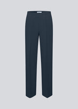 Classic navy pants in navy blue with pressfolds and straight legs. Nelli pants are closed by a hidden zipper at the side with an elastic waistband for a more comfortable fit.