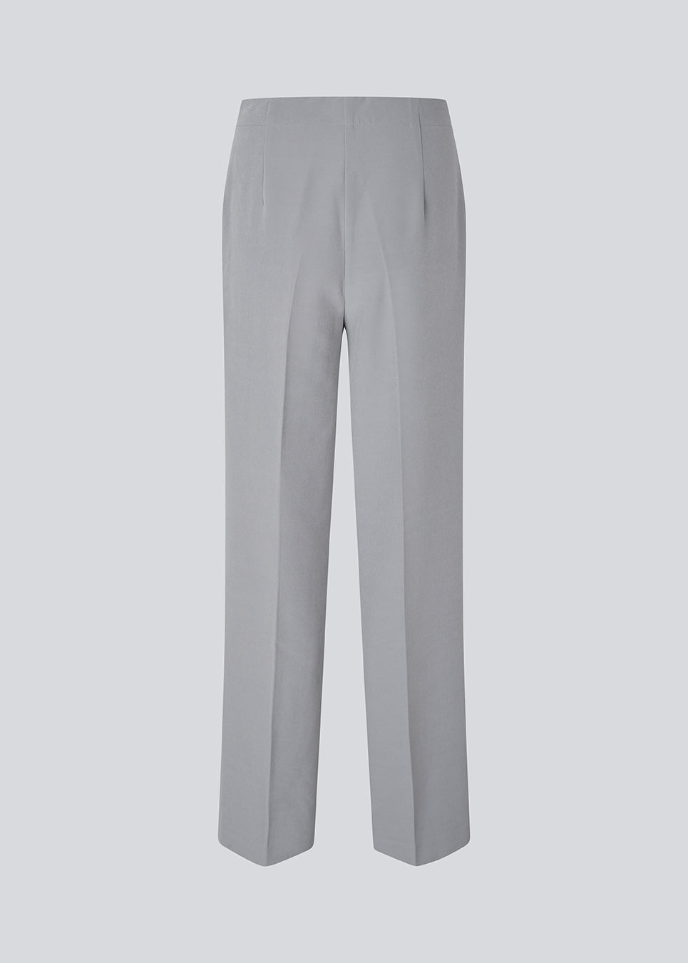 Classic pants in grey with pressfolds and straight legs. Nelli pants are closed by an hidden zipper at the side with an elastic waistband for a more comfortable fit.&nbsp;
