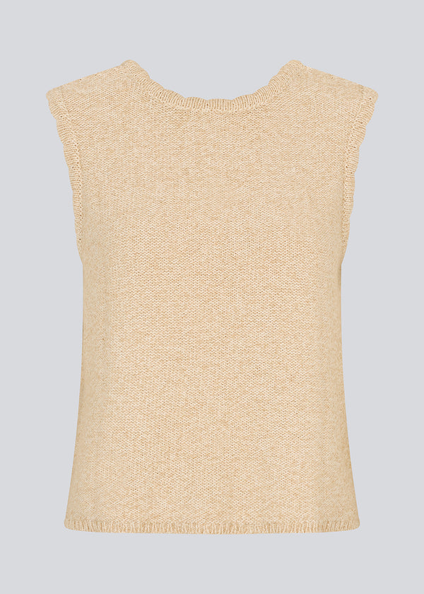 Sleevless knitted top in cotton in beige. NerissaMD top has detailed trimmings and a deep v-neckline in the back.