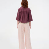 Sleeveless shirt in purple with button closure in EcoVero viscose. NickiMD SS shirt has a loose fit and gathers at the shoulder.