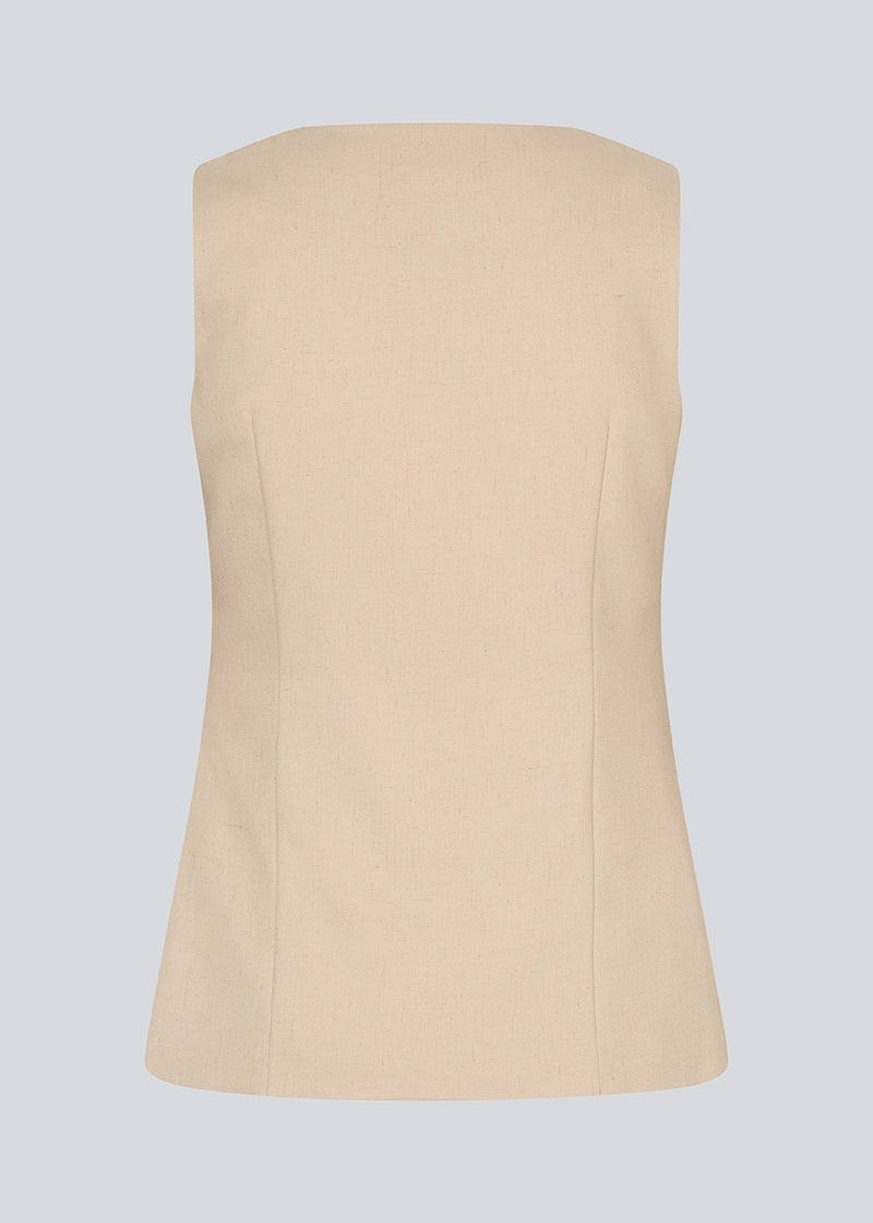 Fitted vest with a v-neck. NormaMD top has a button closure and two pockets in front.