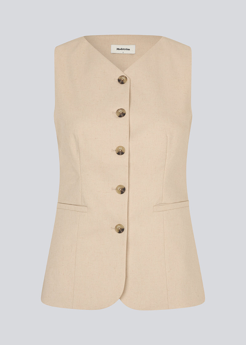 Fitted vest with a v-neck. NormaMD top has a button closure and two pockets in front.