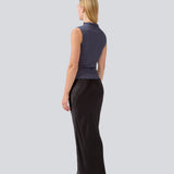 Sleeveless top in a structured material with a high neck. OasisMD top has wavy hems at neckline, arm hole and hem.