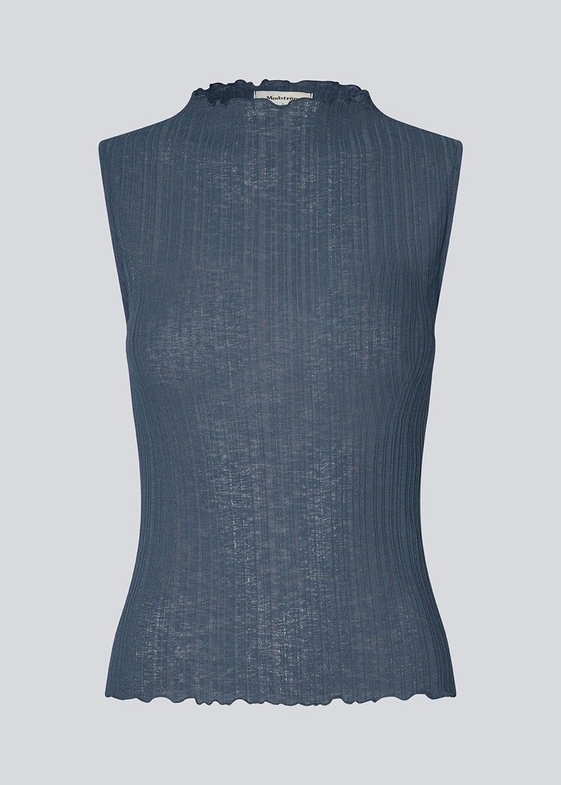 Sleeveless top in a structured material with a high neck. OasisMD top has wavy hems at neckline, arm hole and hem.