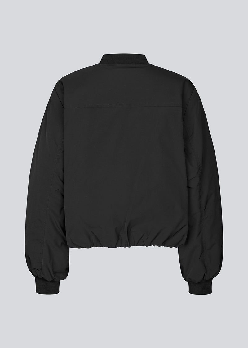 Padded black bomber jacket with gatherings at the sleeves. Obimd jacket is slightly cropped and has a zipper closure and two front pockets.&nbsp;