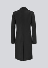 Beautiful, knee-length wool coat in black. Odelia coat is closed at front by 4 buttons and is fitted around the waist, which gives a feminine look. Because of the high content of wool the jacket will be perfect for fall and the mild winters.