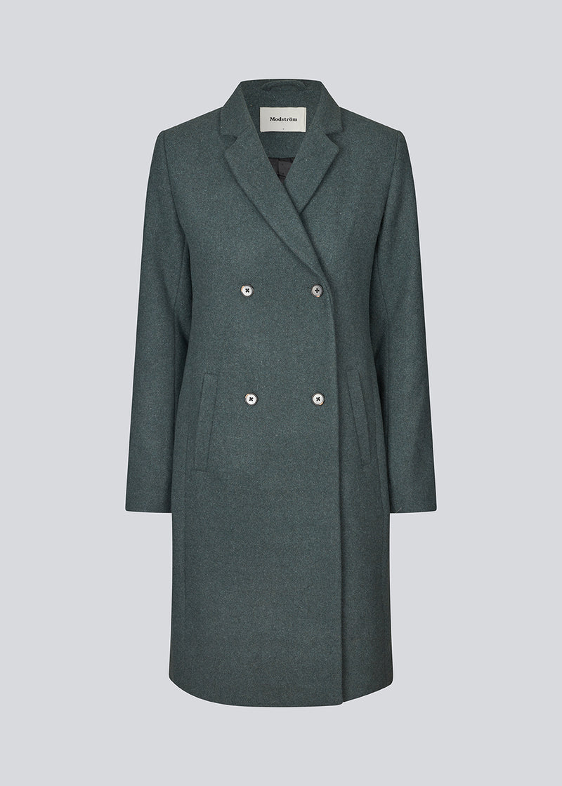 Beautiful, knee-length wool coat in dark olive green. Odelia coat is closed at front by 4 buttons and is fitted around the waist, which gives a feminine look. Because of the high content of wool the jacket will be perfect for fall and the mild winters.