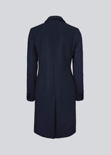 Beautiful, knee-length wool coat in navy sky. Odelia coat is closed at front by 4 buttons and is fitted around the waist, which gives a feminine look. Because of the high content of wool the jacket will be perfect for fall and the mild winters.