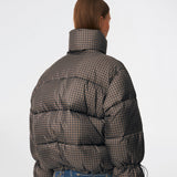 Puffer jacket with a high neck in 100% recycled polyester. Odinmd jacket has a zipper closure and an adjustable strap at the sleeve. The model is 175 cm and wears a size s/36.