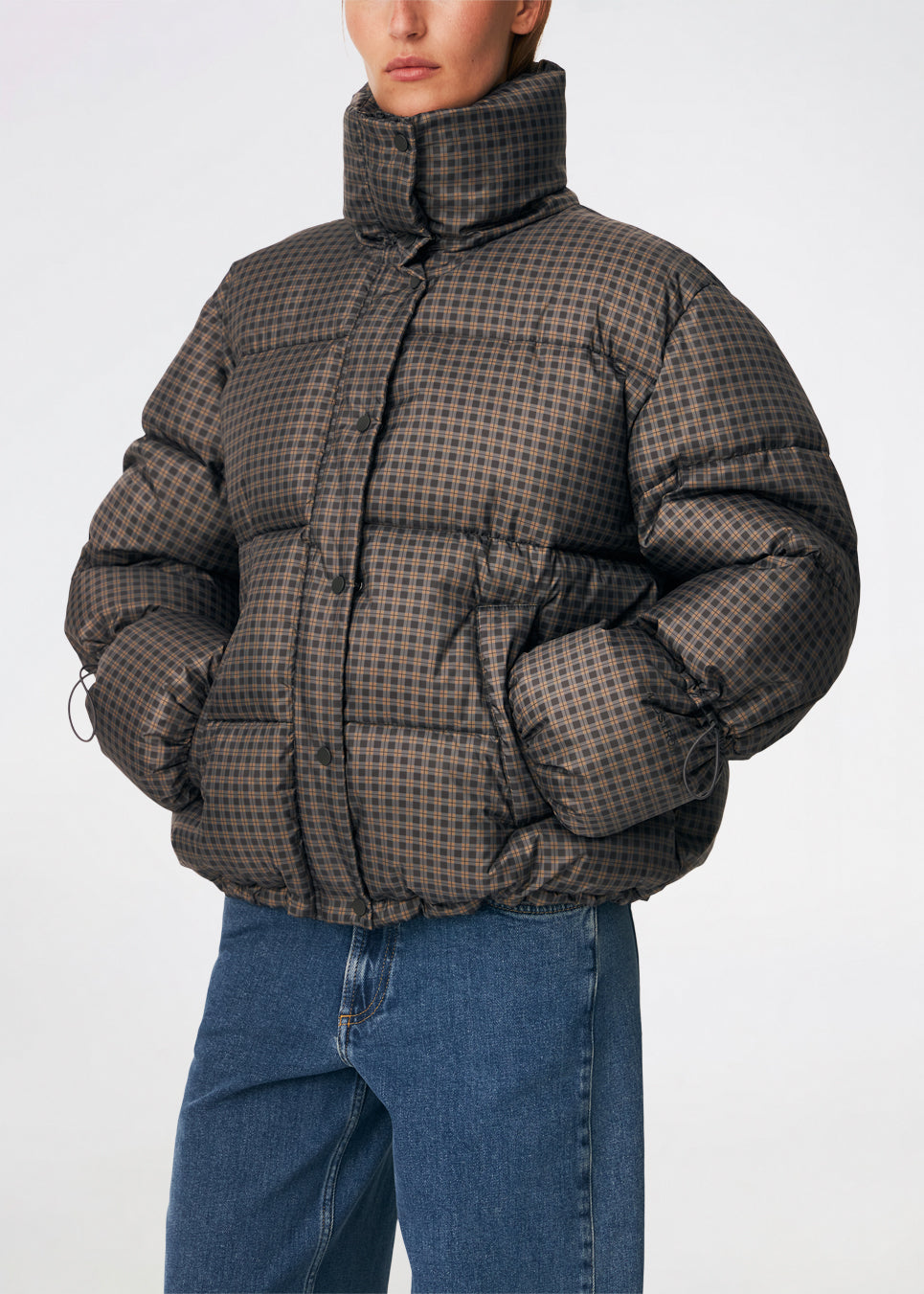 Puffer jacket with a high neck in 100% recycled polyester. Odinmd jacket has a zipper closure and an adjustable strap at the sleeve. The model is 175 cm and wears a size s/36.