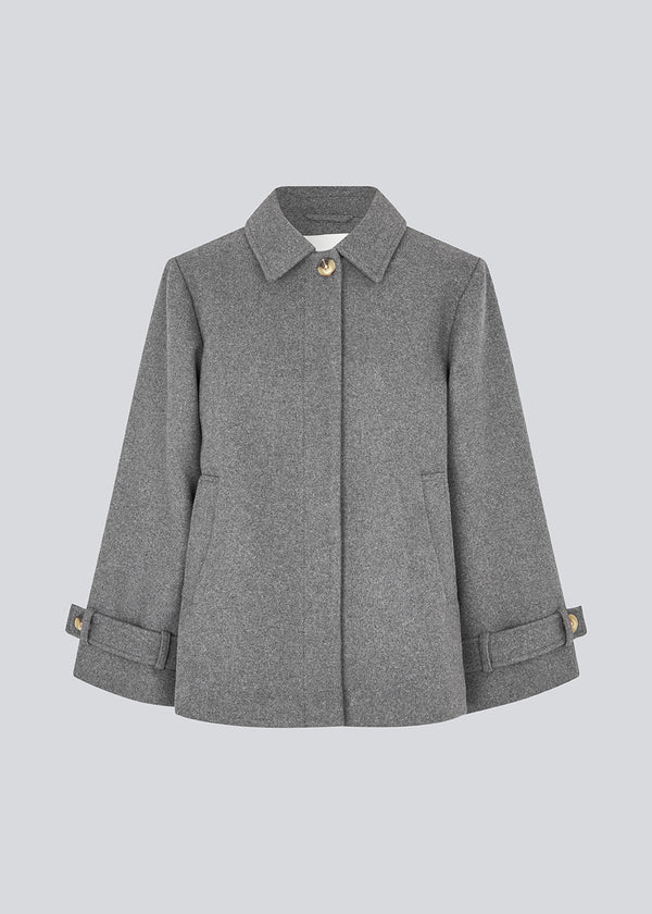 Classic short jacket in a wool mix. Ofiamd jacket has a relaxed fit, hidden button closure and collar. The model is 175 cm and wears a size s/36.