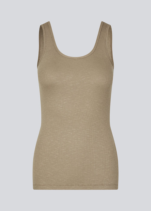 Olla top in light brown is a simple tanktop in a soft ribmaterial. The top has a tight and figure-hugging silhouette which has a soft feel under a knitted sweater or shirt.&nbsp;