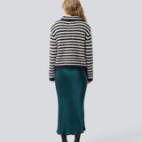 Soft knit in recycled polyester. Packermd rollneck has long sleeves and a high neckline with a side slit. The model is 175 cm and wears a size s/36.