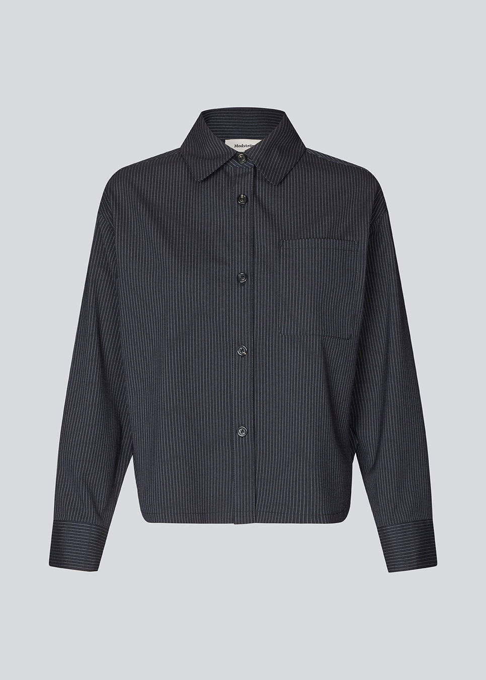 Slightly cropped shirt with wide sleeves. Paitynmd shirt has a front button closure, shirt collar, and a chest pocket.