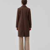 Beautiful, long wool coat in dark brown. Pamela coat is closed by 3 big buttons at front and is waisted, which gives a feminine look. Because of the high content of wool you will be able to keep warm all through fall and the mild winters. The model is 176 cm and wears a size S/36