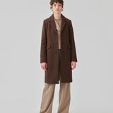 Beautiful, long wool coat in dark brown. Pamela coat is closed by 3 big buttons at front and is waisted, which gives a feminine look. Because of the high content of wool you will be able to keep warm all through fall and the mild winters. The model is 176 cm and wears a size S/36