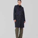 Beautiful, long wool coat in navy. Pamela coat is closed by 3 big buttons at front and is waisted, which gives a feminine look. Because of the high content of wool you will be able to keep warm all through fall and the mild winters.