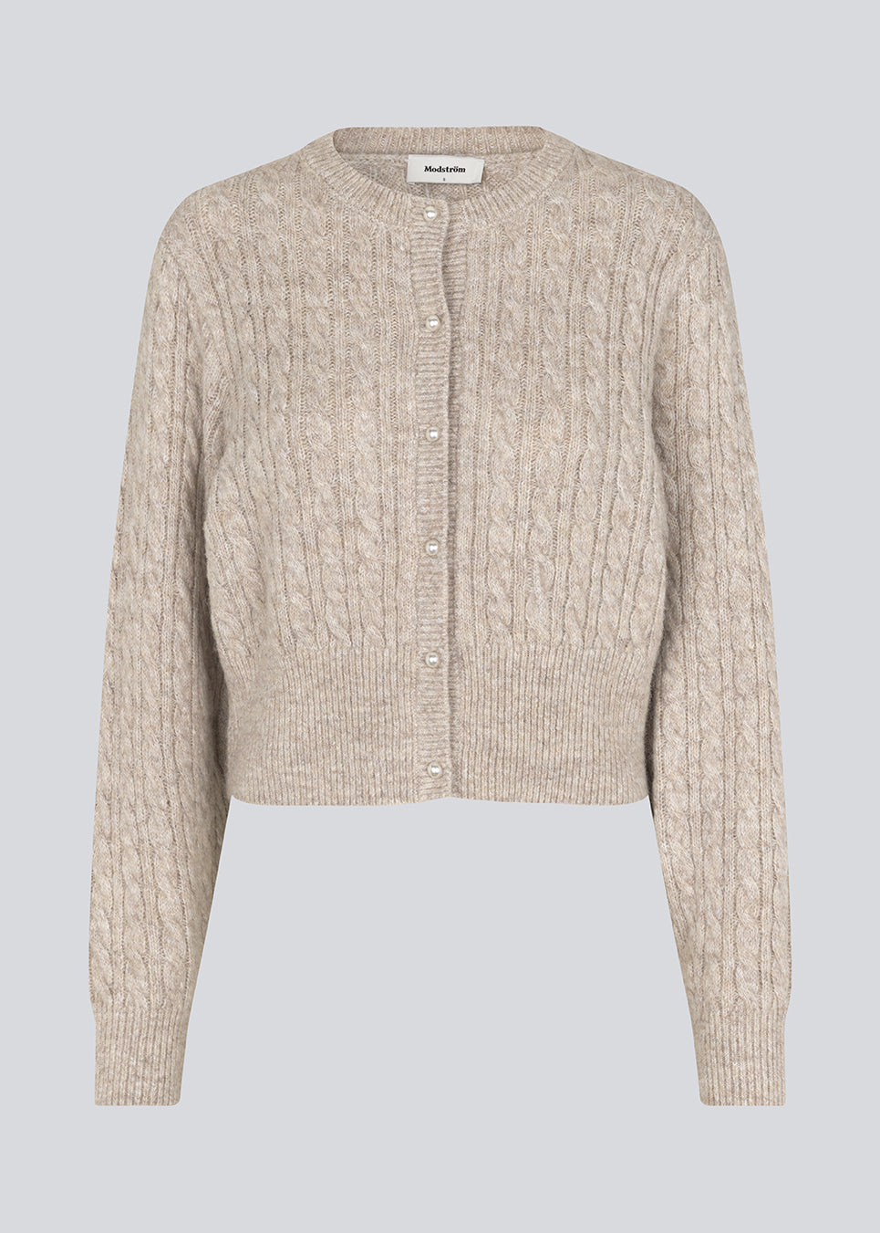 Knitted cable knit cardigan with pearl buttons. Pammiemd cardigan has a round neckline and ribbed hem.