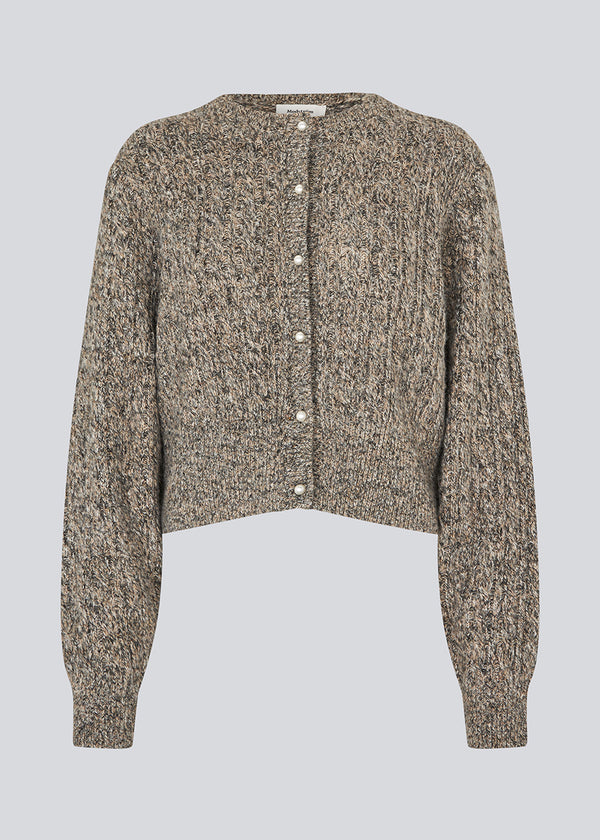 Knitted cable knit cardigan with pearl buttons. &nbsp;Pammiemd cardigan has a round neckline and ribbed hem.&nbsp;