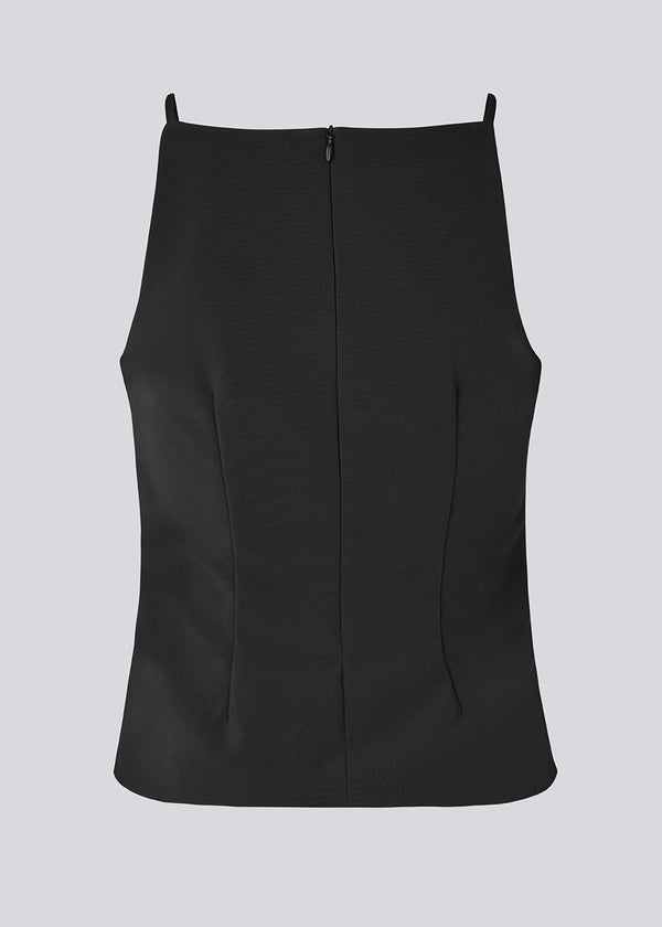 Fitted top with thin straps. Pandymd strap top has a ruffle detail at the side and an invisible back zipper.