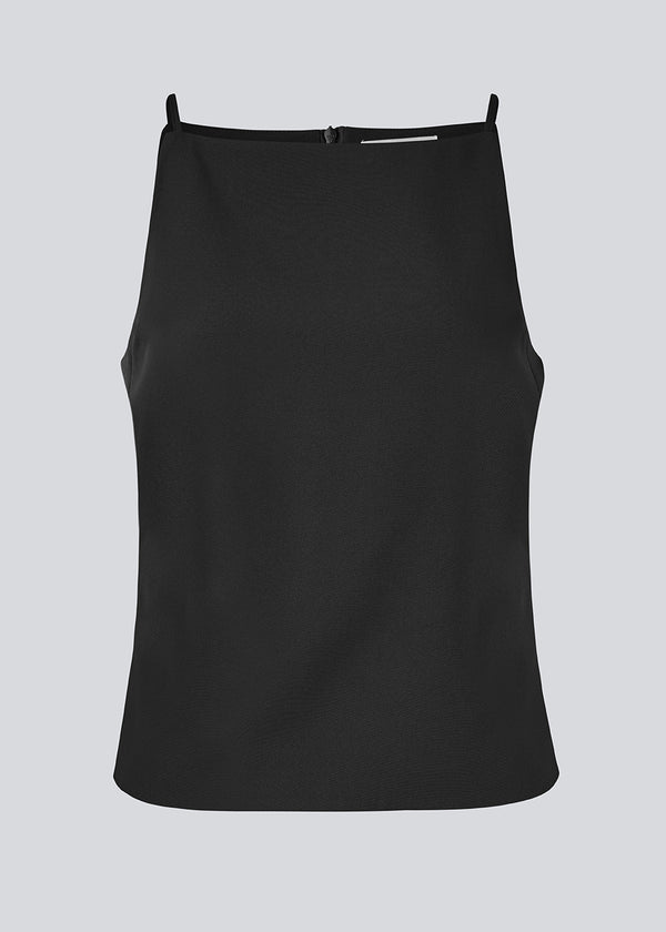 Fitted top with thin straps. Pandymd strap top has a ruffle detail at the side and an invisible back zipper.
