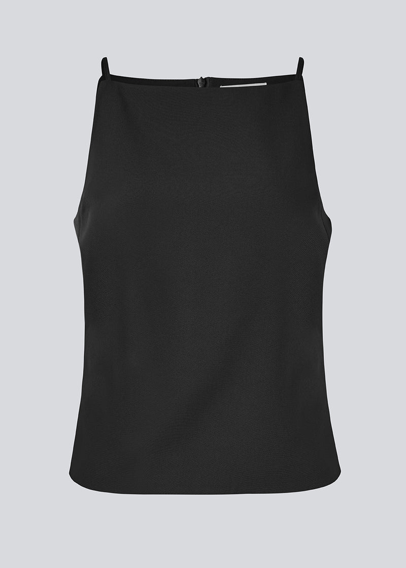 Fitted top with thin straps. Pandymd strap top has a ruffle detail at the side and an invisible back zipper.
