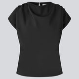 Fitted top with ruffled details. Pandymd top has short sleeves and an opening in the back with button closure.