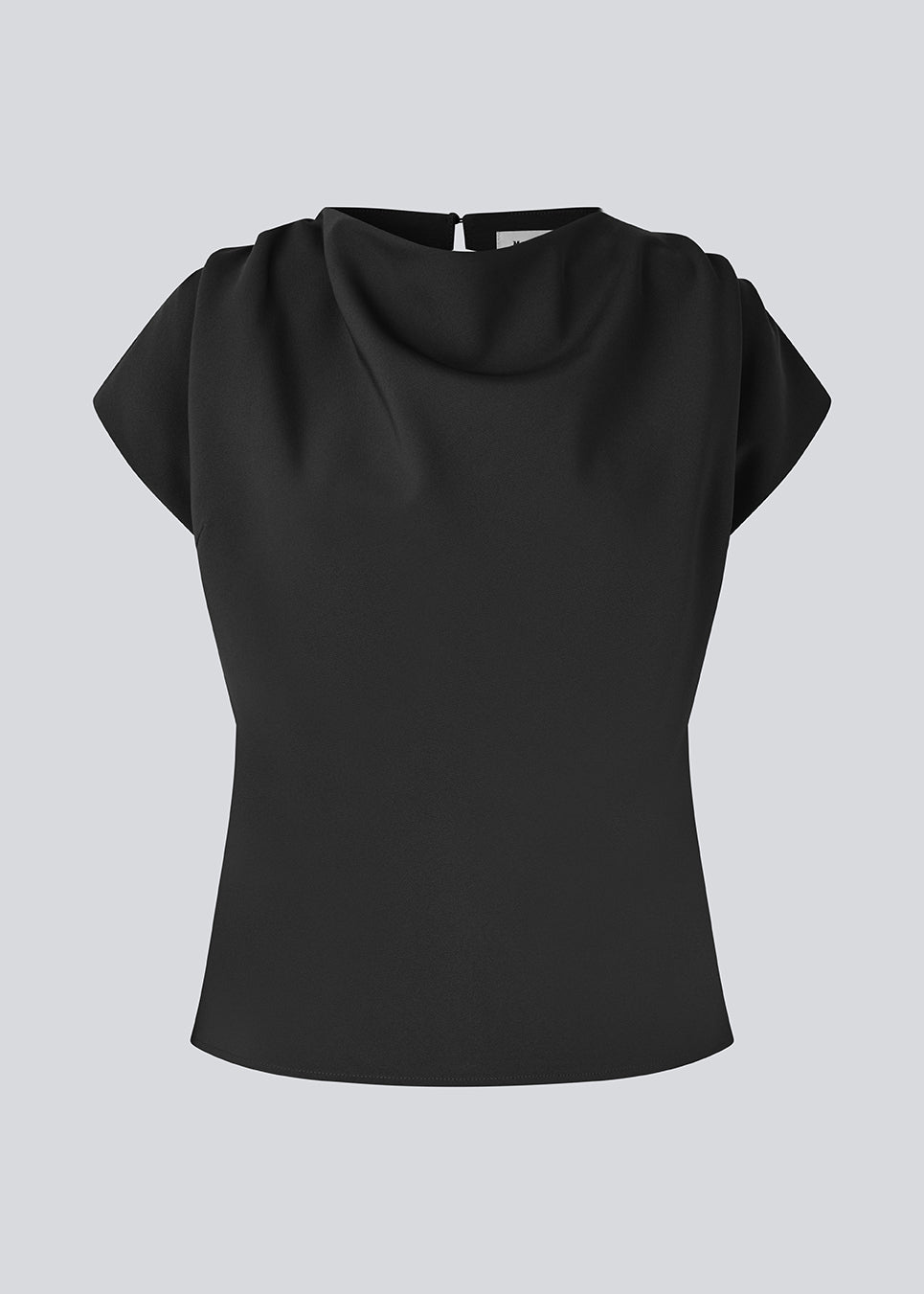 Fitted top with ruffled details. Pandymd top has short sleeves and an opening in the back with button closure.