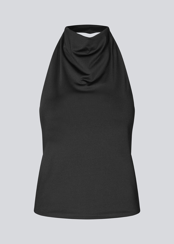Fitted halterneck top without sleeves. Parissamd top has draped details at the front and an open back.