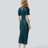 Green long satin dress with draping detail. Parveenmd dress has short sleeves and an invisible zipper in the back. The model is 175 cm and wears a size s/36.