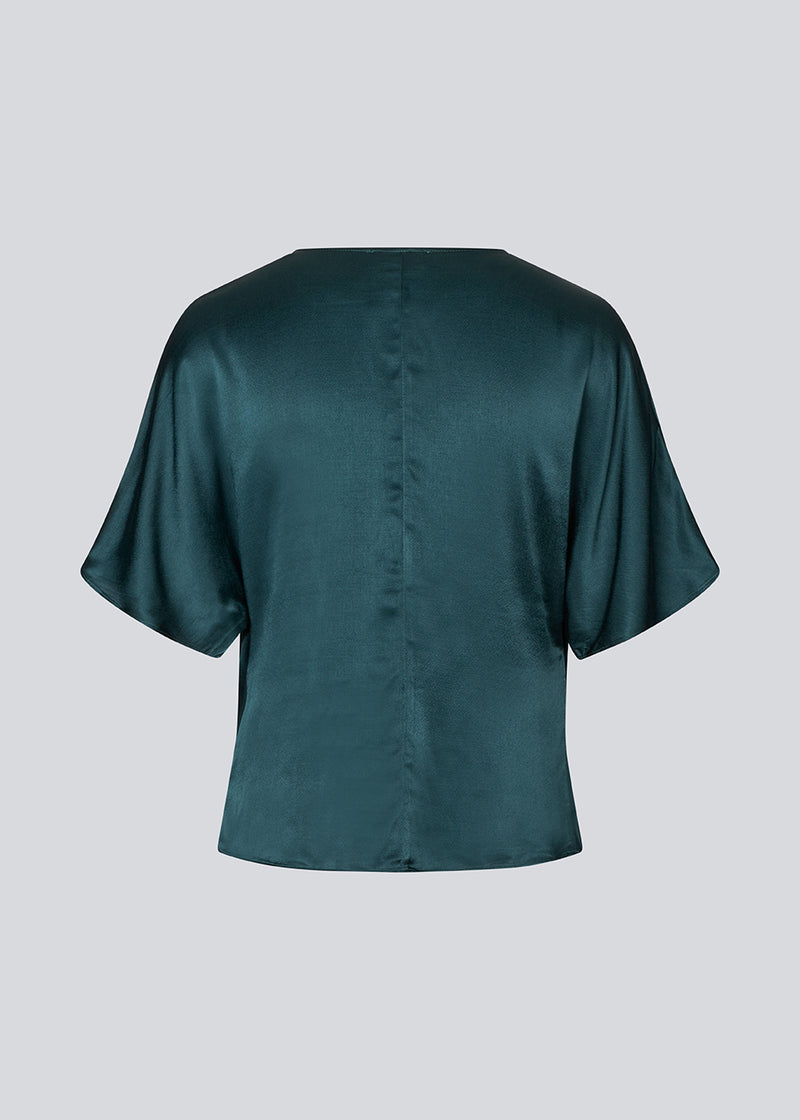 Dark green satin top with a waterfall detail. Parveenmd top is fitted and has short sleeves.&nbsp;
