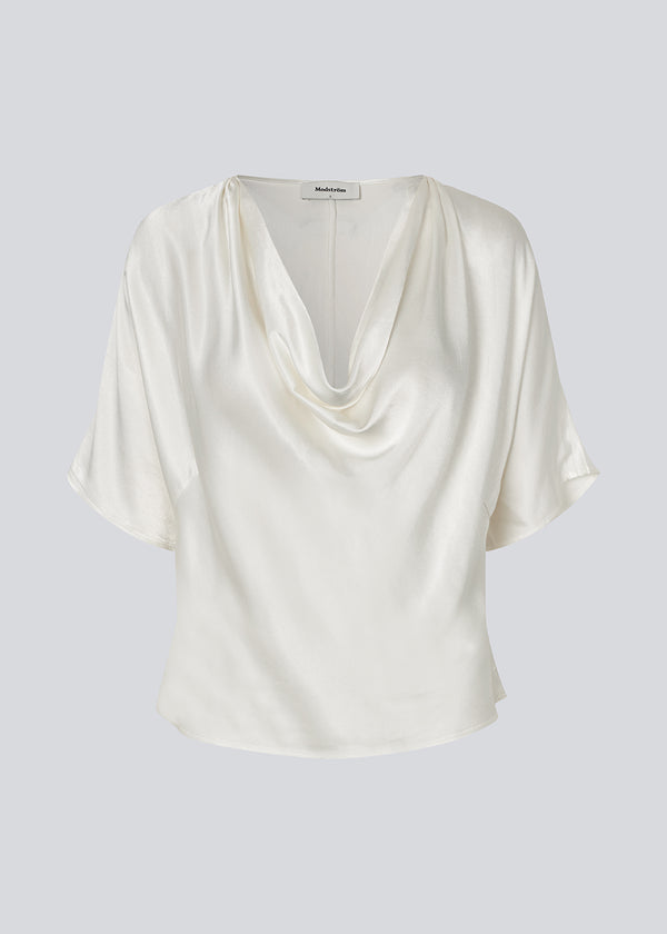 White satin top with a waterfall detail. Parveenmd top is fitted and has short sleeves.&nbsp;