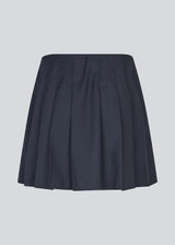 Short skirt with box pleats and a medium high waist. Peggiemd skirt has a hidden zipper in the side. The model is 175 cm and wears a size s/36.