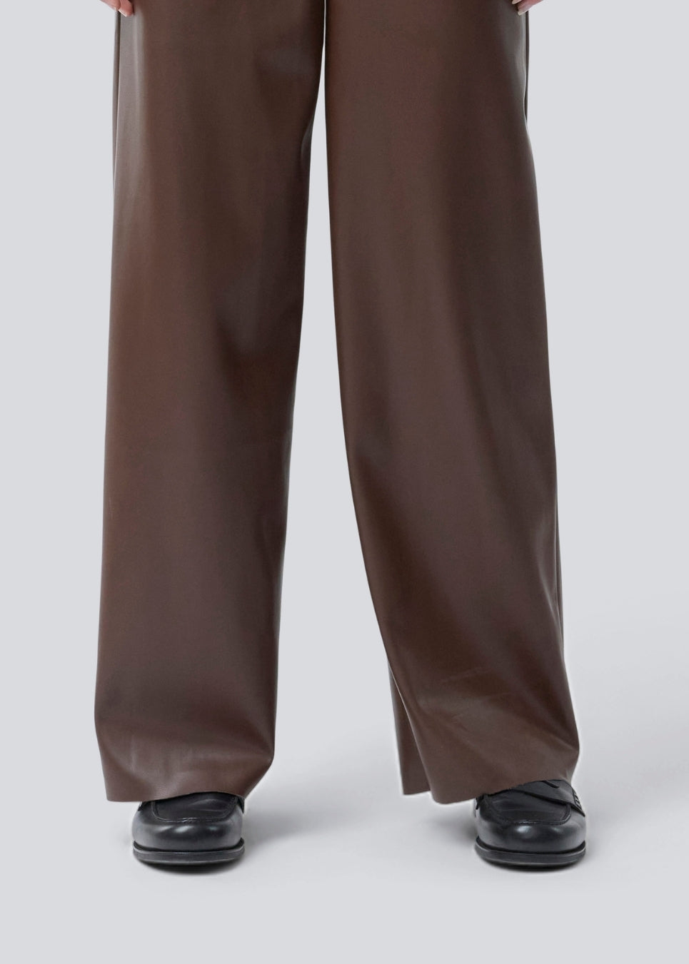 Loose trousers in 100% PU. Pellemd pants have a high waist with elastic and side pockets. The model is 175 cm and wears a size s/36.