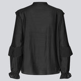 Black Shirt with ruffle details and a front opening. Phungmd shirt has a loose fit and flowy sleeves.