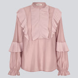 Shirt in the color "Fragrant Lilac" with ruffle details and a front opening. Phungmd shirt has a loose fit and flowy sleeves.