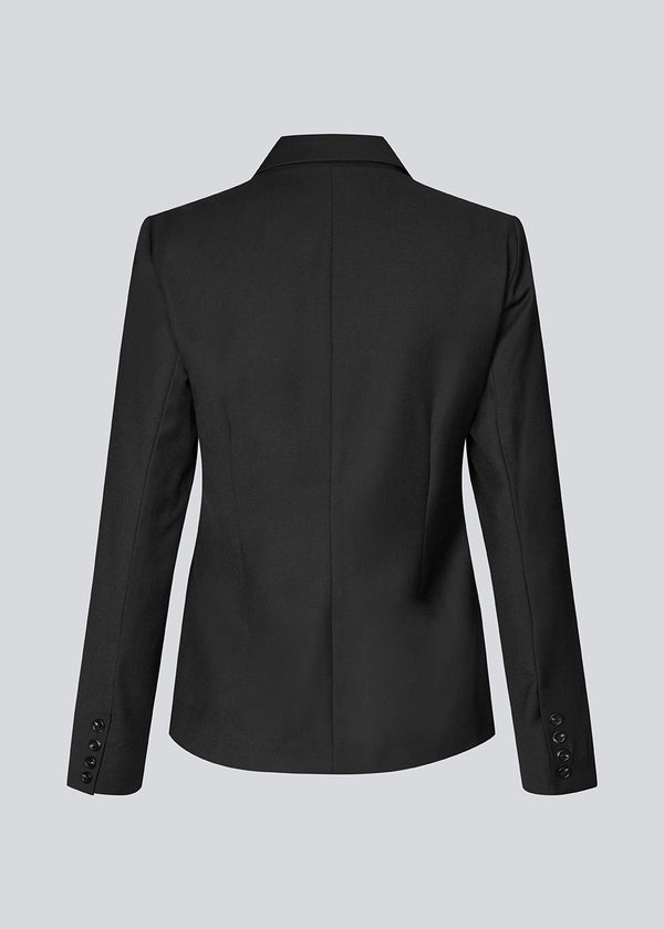 Slightly fitted blazer with a v-neck. Piloumd blazer has two front pockets and a slit at the sleeve with button closure.