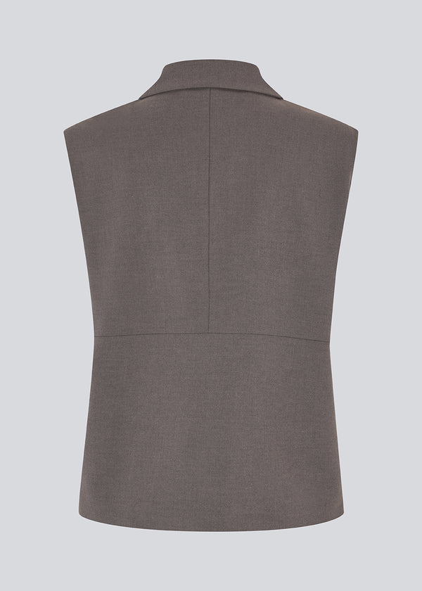 Grey loose vest with a hidden front button closure. Primrosemd vest has a shirt collar and two front pockets.&nbsp;
