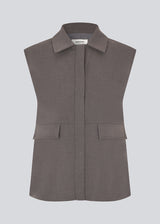 Grey loose vest with a hidden front button closure. Primrosemd vest has a shirt collar and two front pockets.&nbsp;
