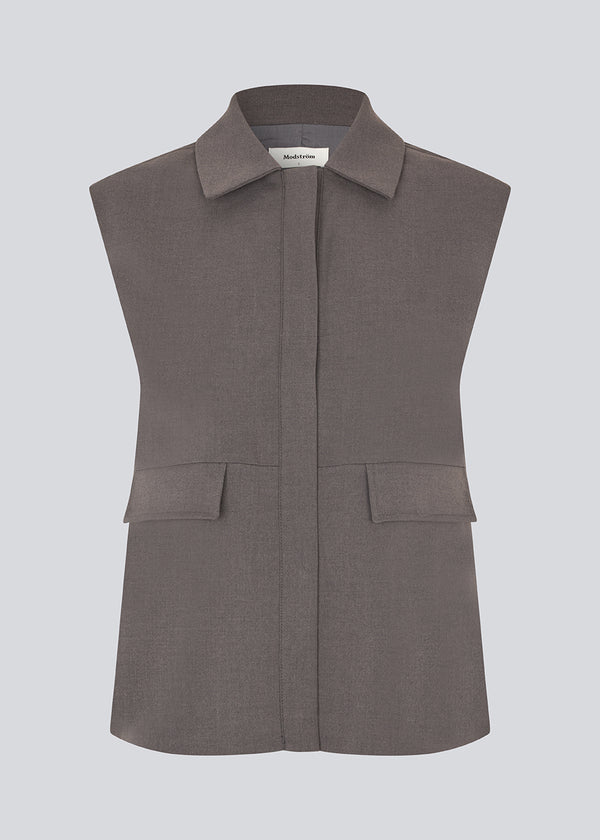Grey loose vest with a hidden front button closure. Primrosemd vest has a shirt collar and two front pockets.&nbsp;
