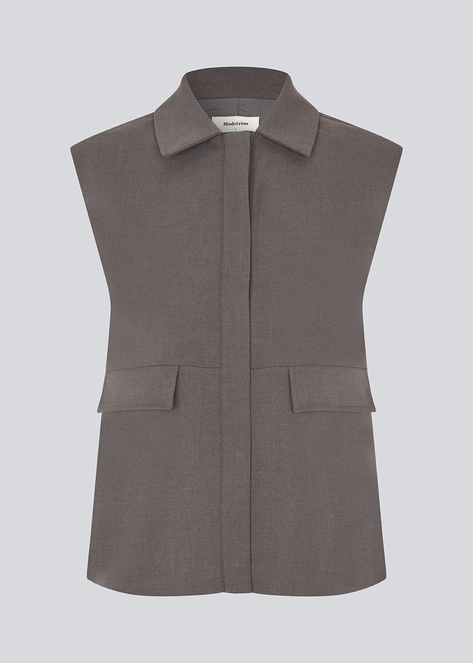 Grey loose vest with a hidden front button closure. Primrosemd vest has a shirt collar and two front pockets.&nbsp;
