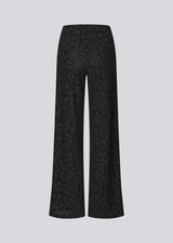 Elastic black trousers with wide legs. The Ricardomd pants are sleek with a metallic floral pattern – ideal for both everyday and festive occasions.