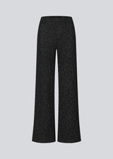 Elastic black trousers with wide legs. The Ricardomd pants are sleek with a metallic floral pattern – ideal for both everyday and festive occasions.