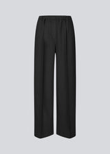 Black trousers with wide legs and pleats. The Ridermd pants feature side pockets and an elastic waistband – sleek and comfortable at the same time.