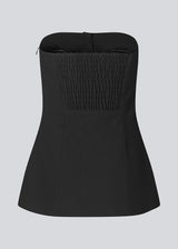 Black corset top with button details. The Ridermd top features a smocked back and invisible zipper – a flattering and timeless piece.