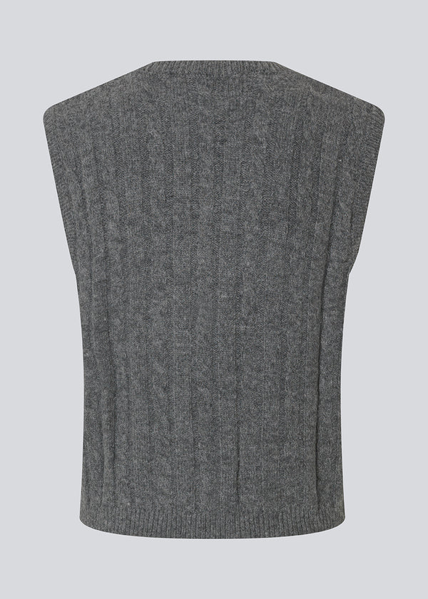 Fitted cable knit vest. The Risemd Vest features a timeless cable knit design and an embroidered logo on the chest – perfect for a cool, classic layered look.
