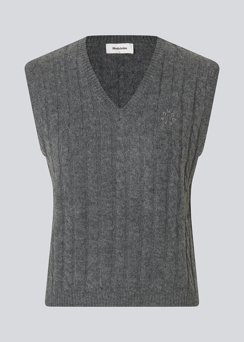 Fitted cable knit vest. The Risemd Vest features a timeless cable knit design and an embroidered logo on the chest – perfect for a cool, classic layered look.
