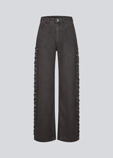 Light black/grey Jeans with wide legs. The Riyamd pants feature a high waist and decorative details along the legs – giving them a cool and edgy look.
