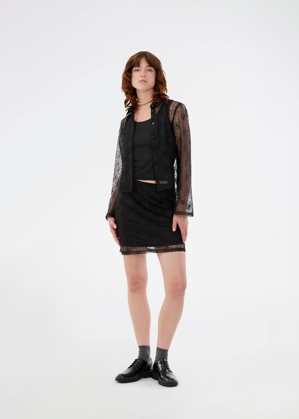 Black fitted shirt in sheer material. The Roccomd shirt features a classic collar and button closure with beautifully stitched rose embroidery – both feminine and stylish.